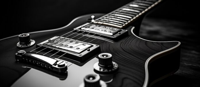A black and white closeup image of a vintage electric guitar with plenty of copy space Neben Kunst, Uhren oder Wein rückt nun ein Objekt ins Rampenlicht, das Musikerherzen höherschlagen lässt: die Vintage-Gitarre.