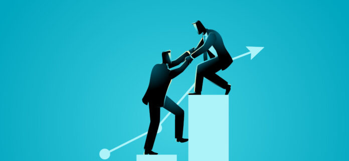 Businessman helping his friend climbing to higher chart