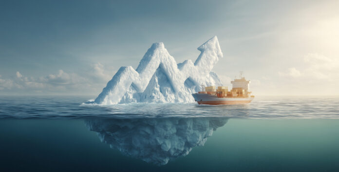 Cargo ship sailing past an iceberg shaped like an upward trending financial graph