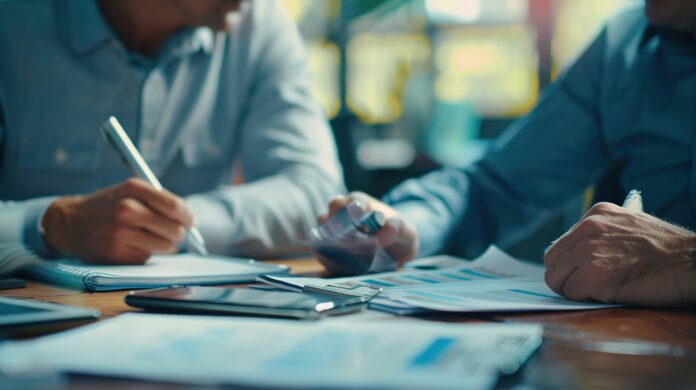 Entrepreneur discussing business financing options with a loan officer, exploring avenues for capital investment and growth.