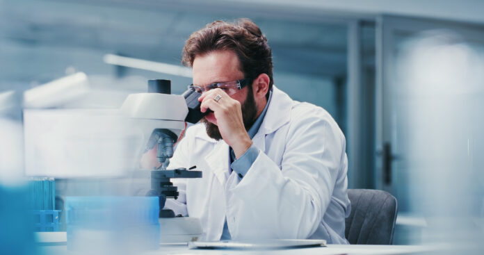 Man, scientist or microscope with glasses in laboratory for medical research, investigation or exam. Male person, biotechnology or experiment with test for forensic study, clinic trial or results GBA erhält mit Bridgepoint einen neuen Mehrheitseigentümer. Geplant sind Expansion, Digitalisierung und weitere Akquisitionen.