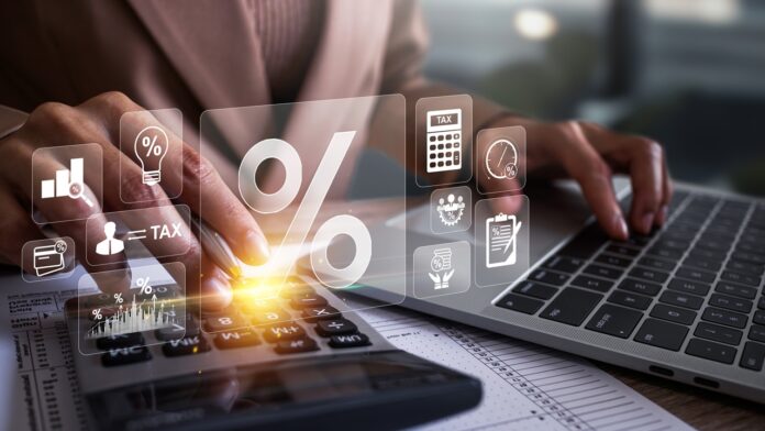 Businesswoman calculating annual taxes and paying taxes. Tax deduction planning concept. Expenses, account, VAT, income tax, Calculation of taxes, expenses, exemptions, deductions, donations